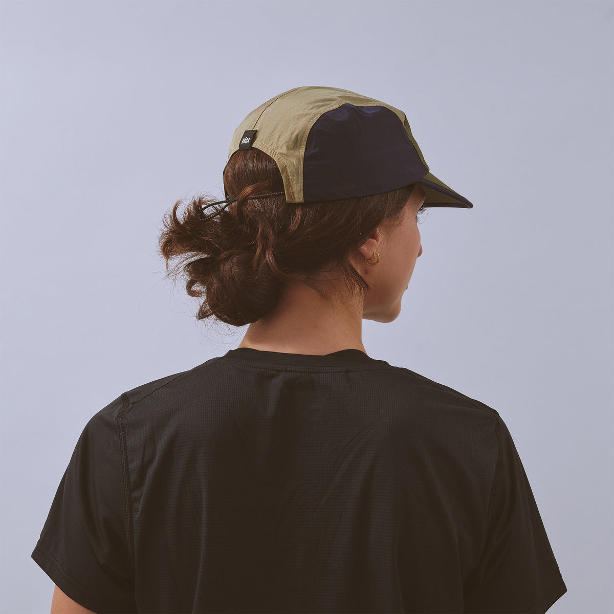 Pacer Cap - Navy Blue / Utility Green / Taupe — VÅGA running cap — worn, additional angle