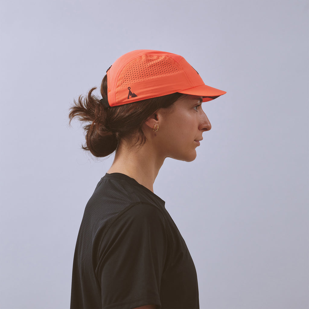 Feather Racing Cap - Neon Coral — VÅGA running cap — worn, alternate angle