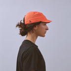 Feather Racing Cap - Neon Coral — VÅGA running cap — worn, alternate angle