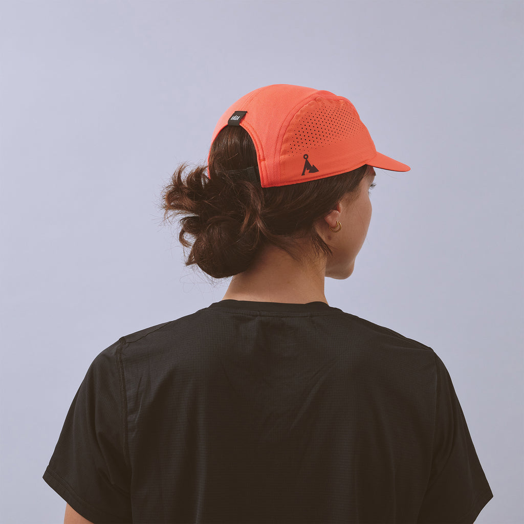 Feather Racing Cap - Neon Coral — VÅGA running cap — worn, additional angle