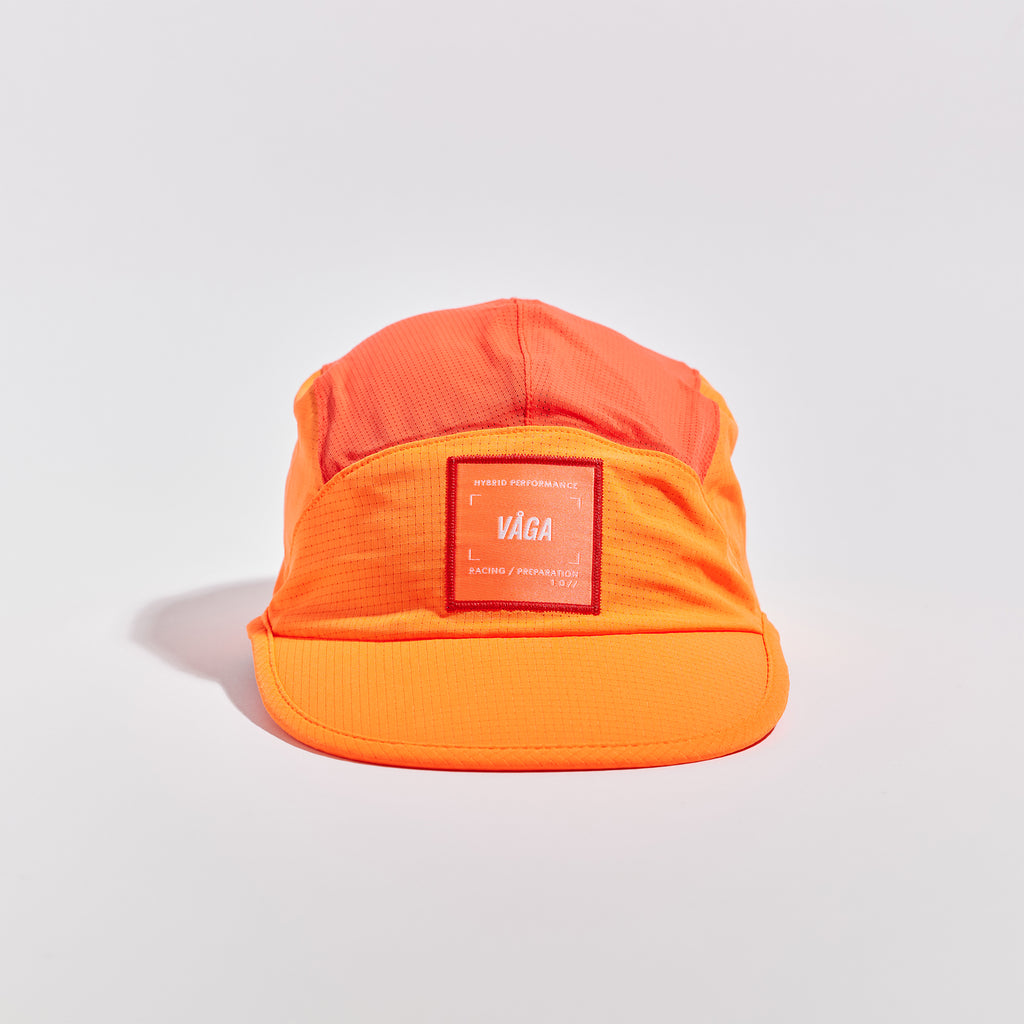 Transit Lite Cap - Neon Orange / Coral — VÅGA running cap — angled view