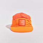 Transit Lite Cap - Neon Orange / Coral — VÅGA running cap — angled view