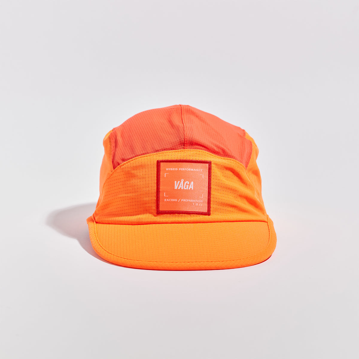 Transit Lite Cap - Neon Orange / Coral — VÅGA running cap — angled view