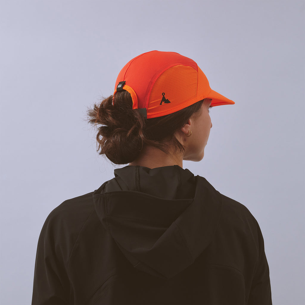 Transit Lite Cap - Neon Orange / Coral — VÅGA running cap — worn, back view