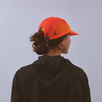 Transit Lite Cap - Neon Orange / Coral — VÅGA running cap — worn, back view