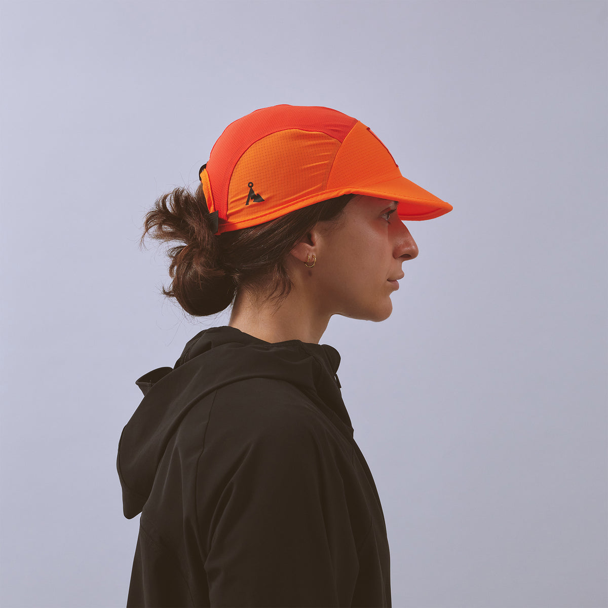 Transit Lite Cap - Neon Orange / Coral — VÅGA running cap — worn, side profile