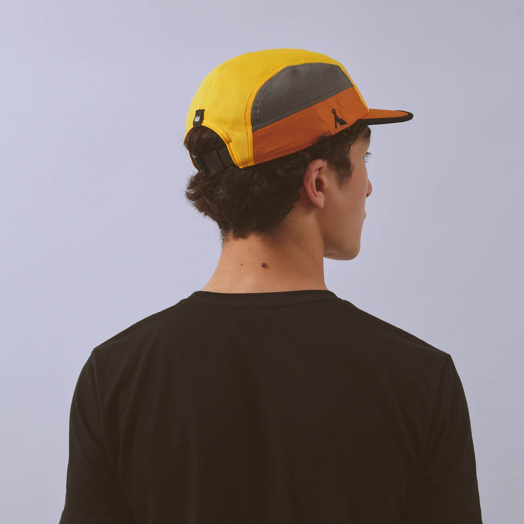 Club Cap - Yellow / Amber / Charcoal — VÅGA running cap — worn, back angled view