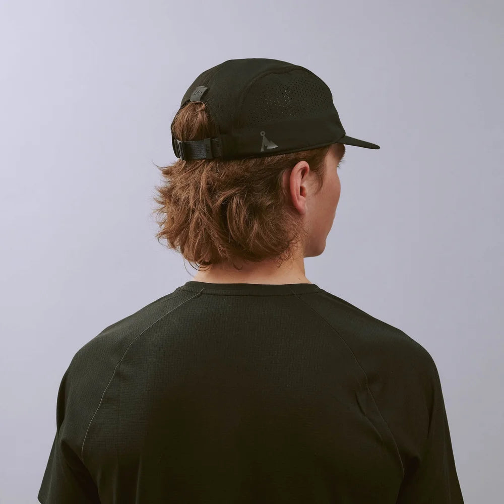 Feather Racing Cap - Black — VÅGA running cap — worn, angled view