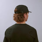 Feather Racing Cap - Black — VÅGA running cap — worn, angled view