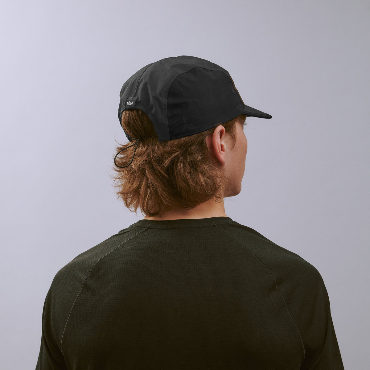 Pacer Cap - Charcoal / Black / Brown — VÅGA running cap — worn, back angled view