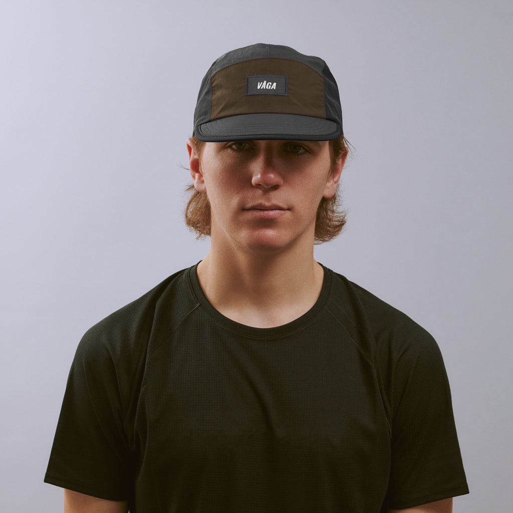 Pacer Cap - Charcoal / Black / Brown — VÅGA running cap — worn, front view