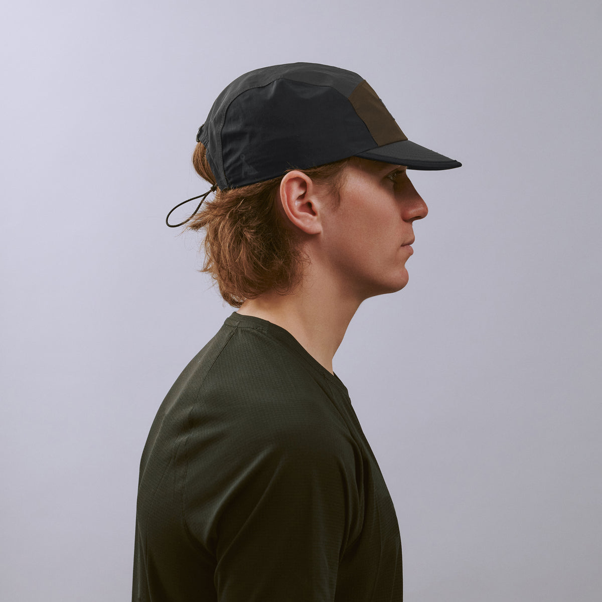 Pacer Cap - Charcoal / Black / Brown — VÅGA running cap — worn, side profile