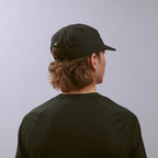 Pacer Cap - Storm Black — VÅGA running cap — worn, angled view